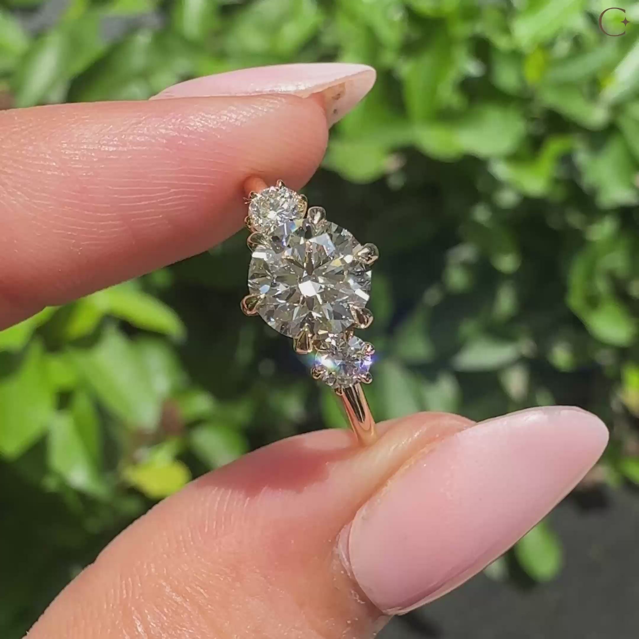 Three stone round engagement ring in 6 claw prong setting.
