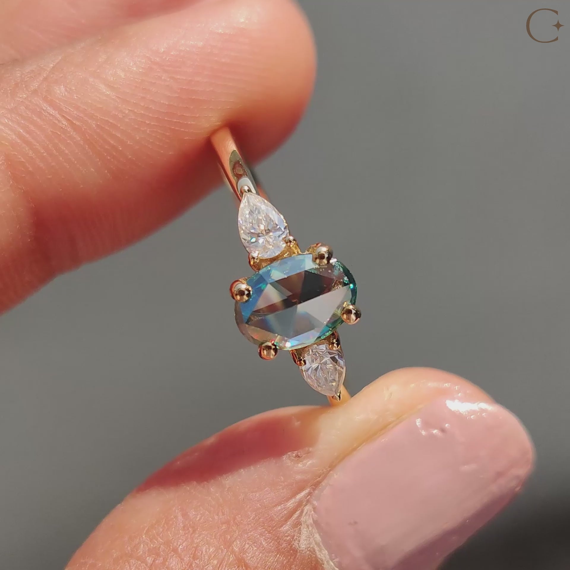 Yellow gold engagement ring with oval and pear cut stones