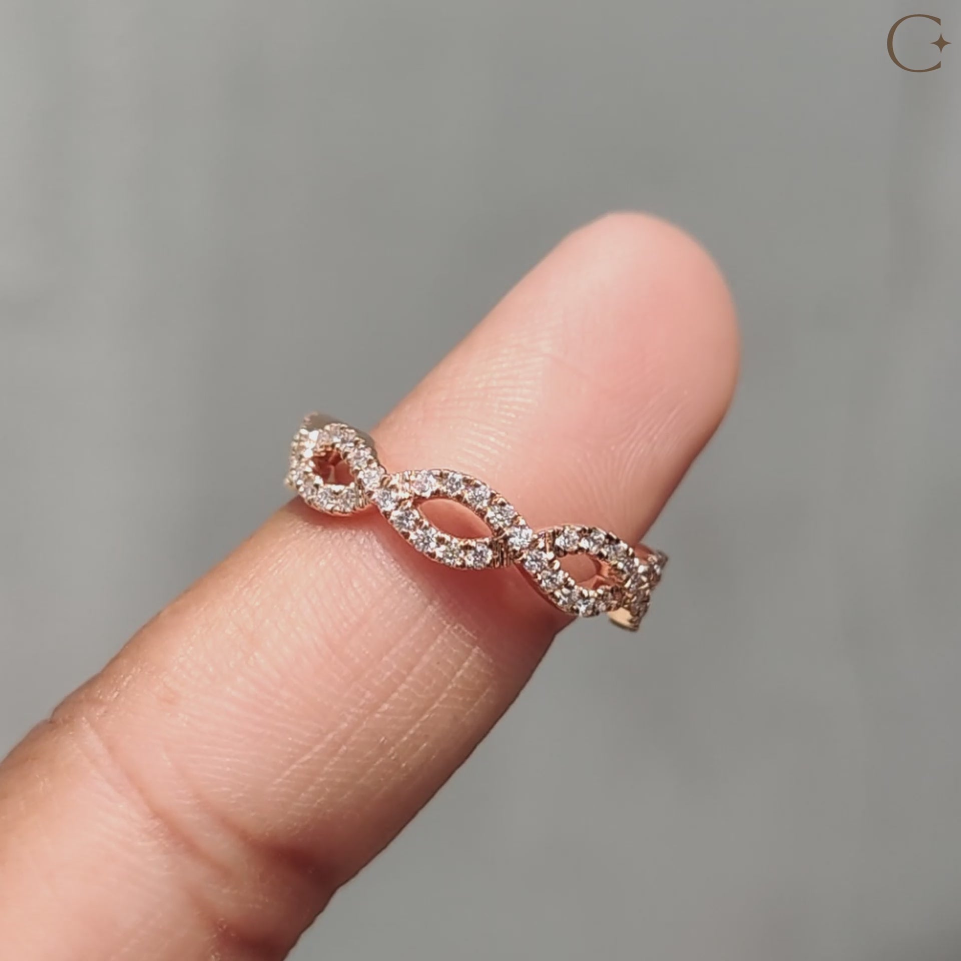 Unique twisted wedding band featuring brilliant diamond accents for a modern look.