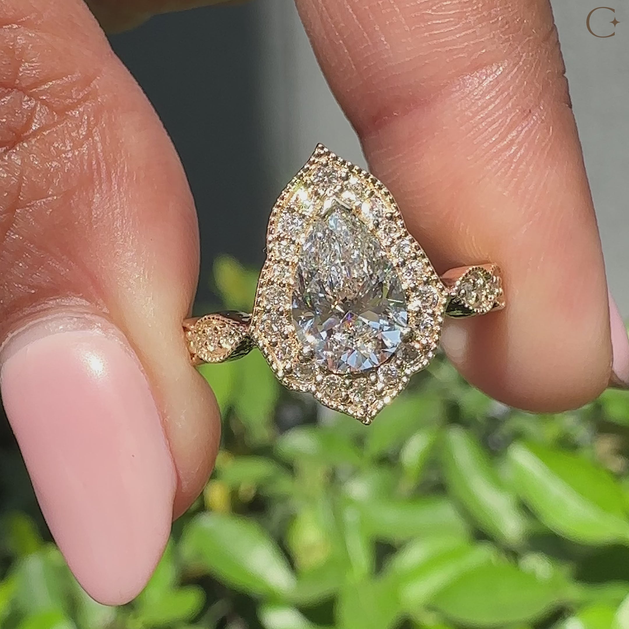 Pear halo engagement ring with cathedral setting and milgrain design in yellow gold.