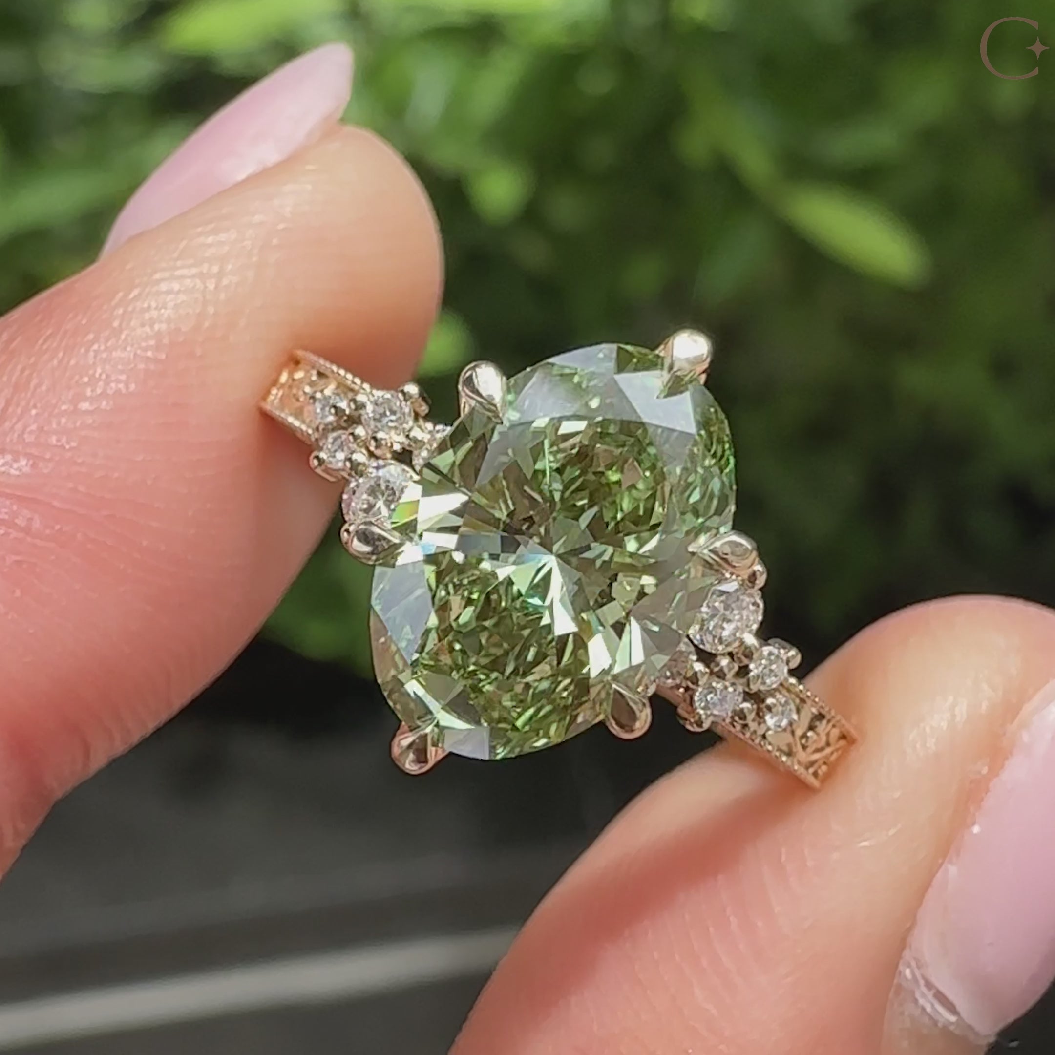 Floral engraved band on green oval engagement ring
