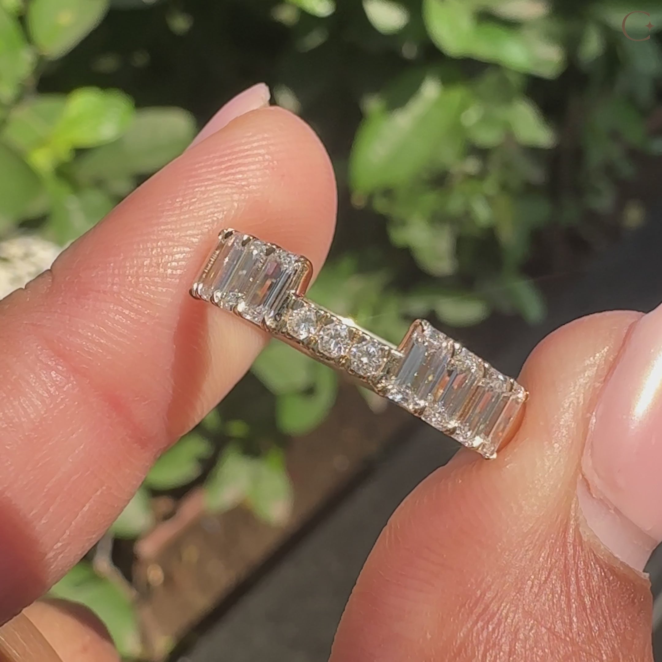 Handmade stackable wedding band featuring emerald and round diamond.
