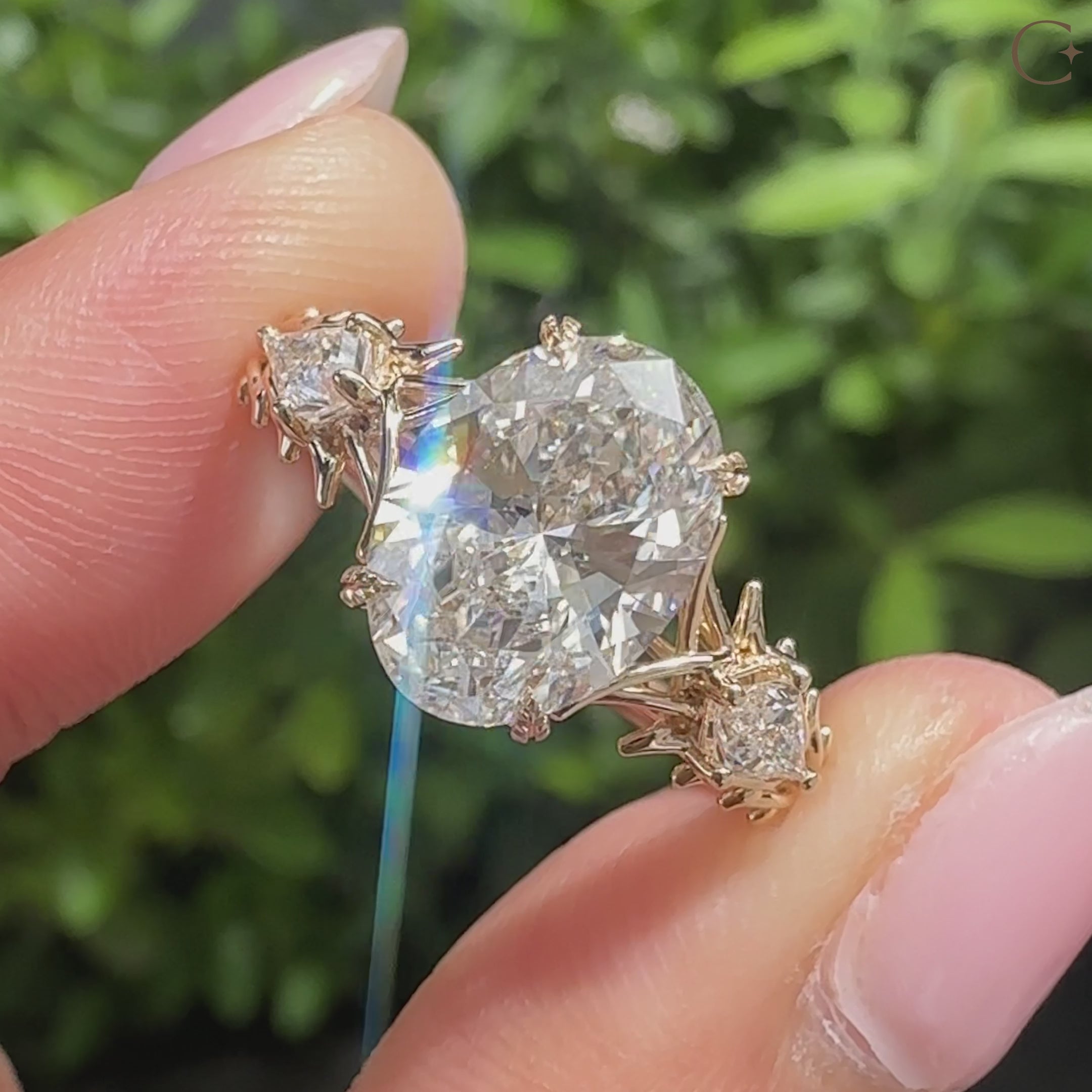 Thorns style three stone ring with oval diamond
