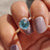 A cyan blue moissanite ring shines with brilliant sparkle and eco-friendly sourcing.