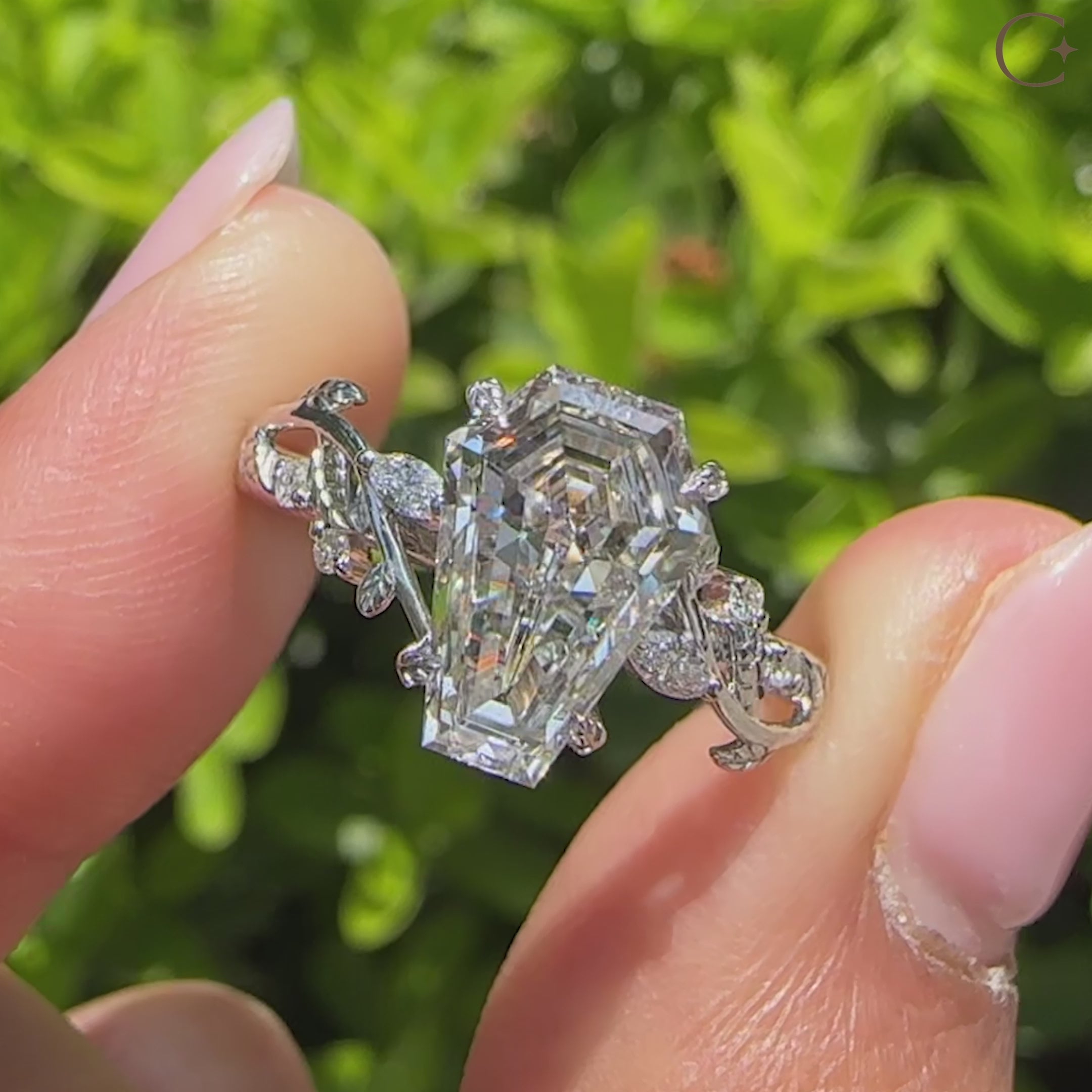 Coffin diamond ring with marquise and round side stones.
