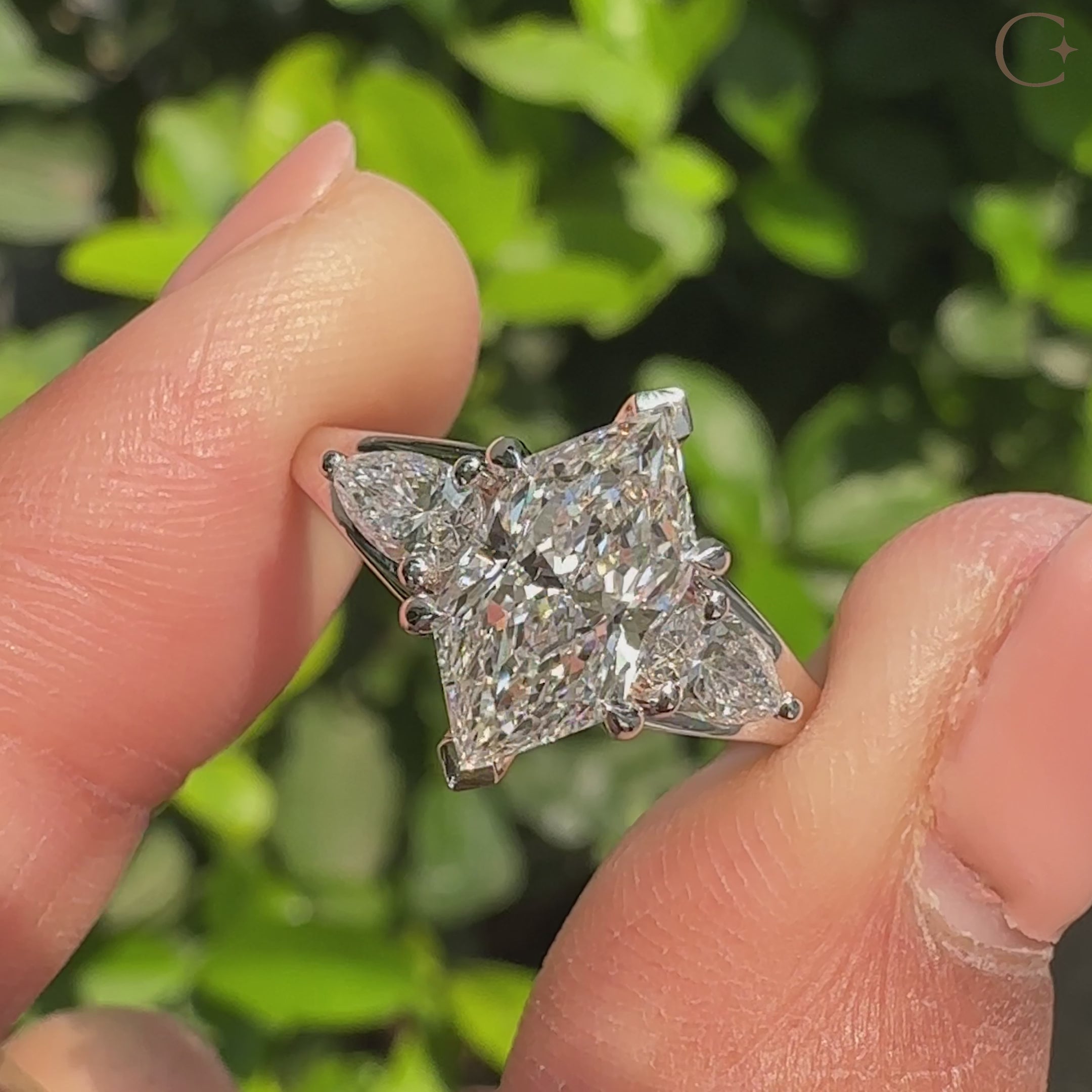 Three stone marquise diamond ring with pear side accents.
