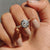 A bezel solitaire ring securely holds the gemstone with elegance.