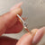 A round cut diamond ring in gold
