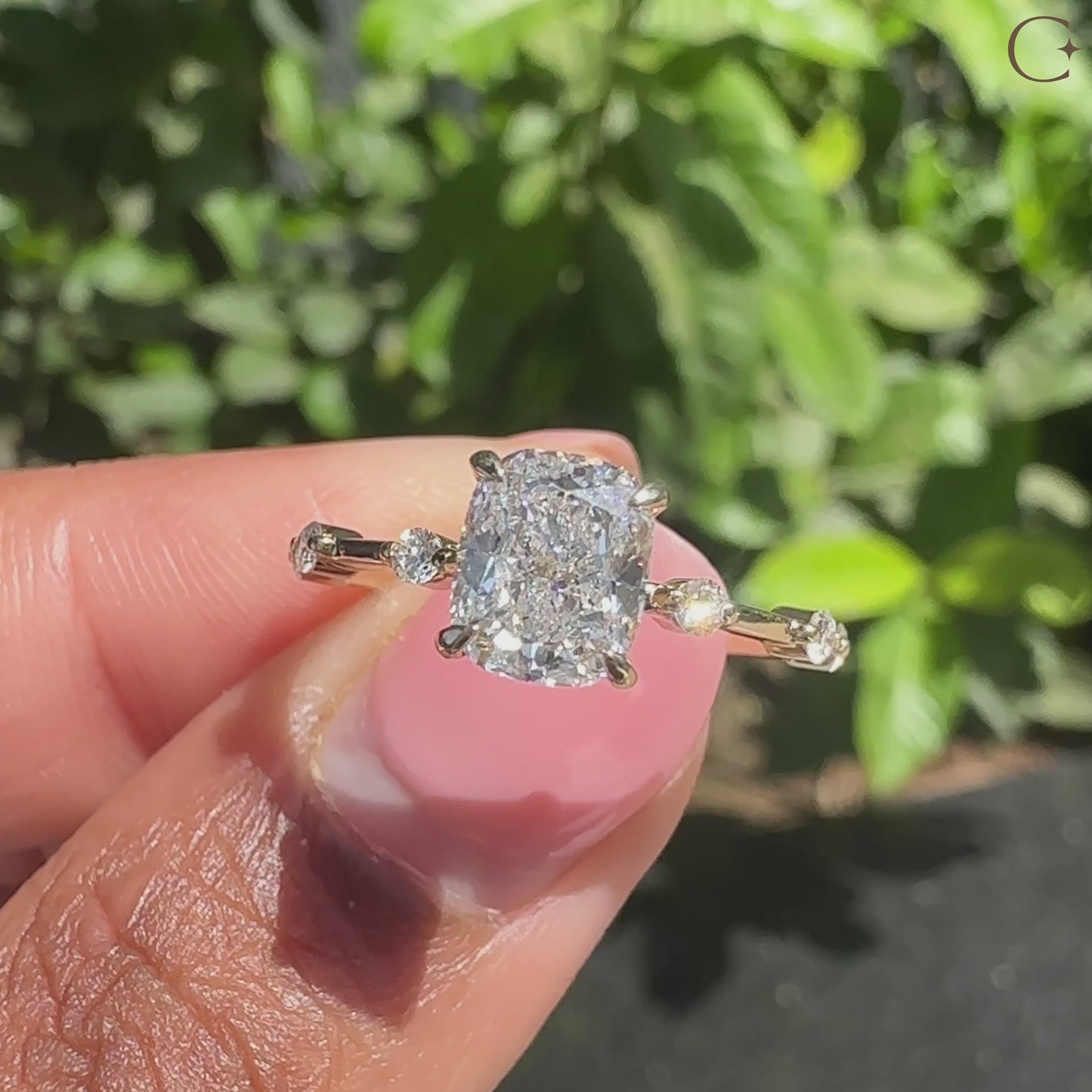 Cushion cut diamond ring with a modern pave setting, set in yellow gold.
