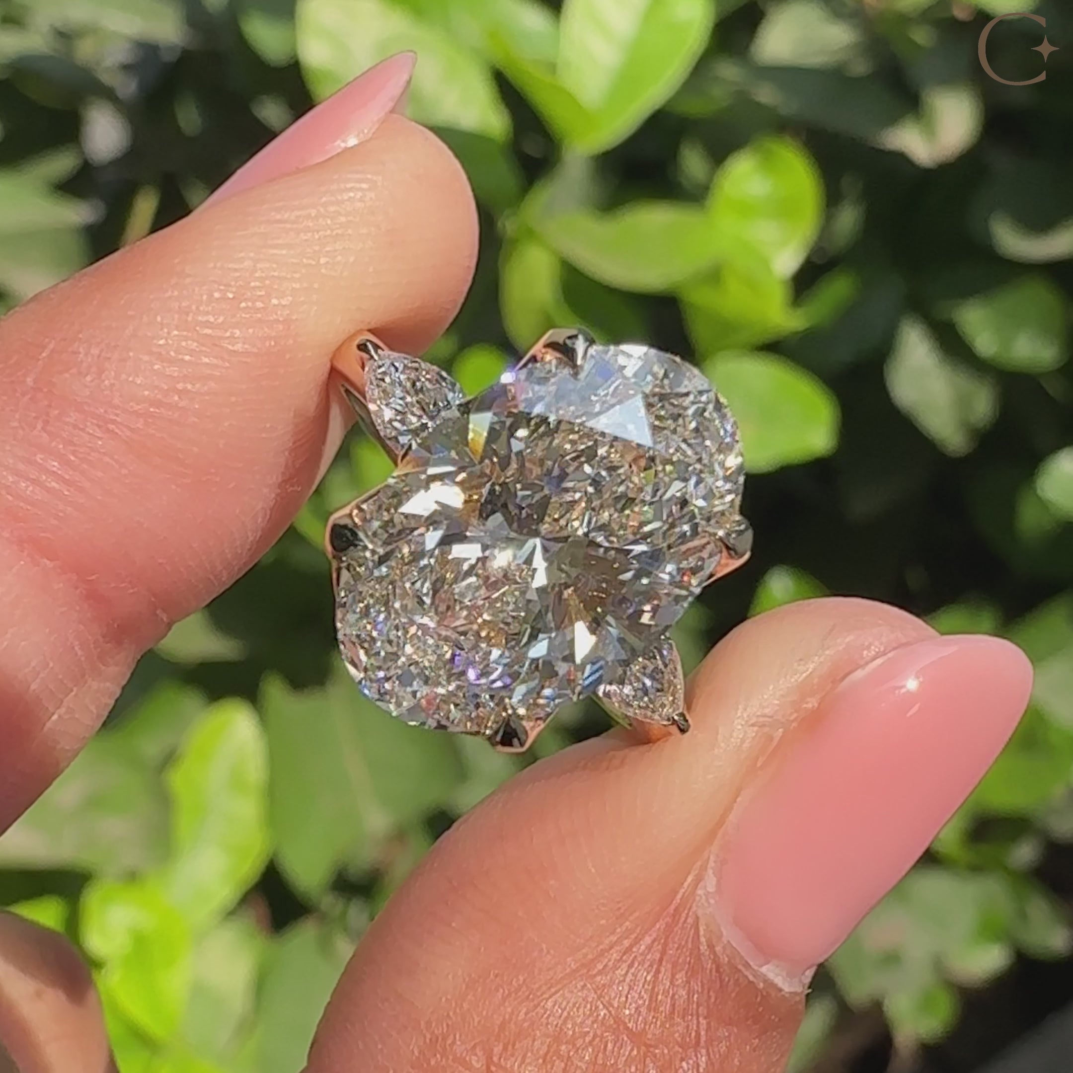 Oval center diamond ring with pear side stone accents
