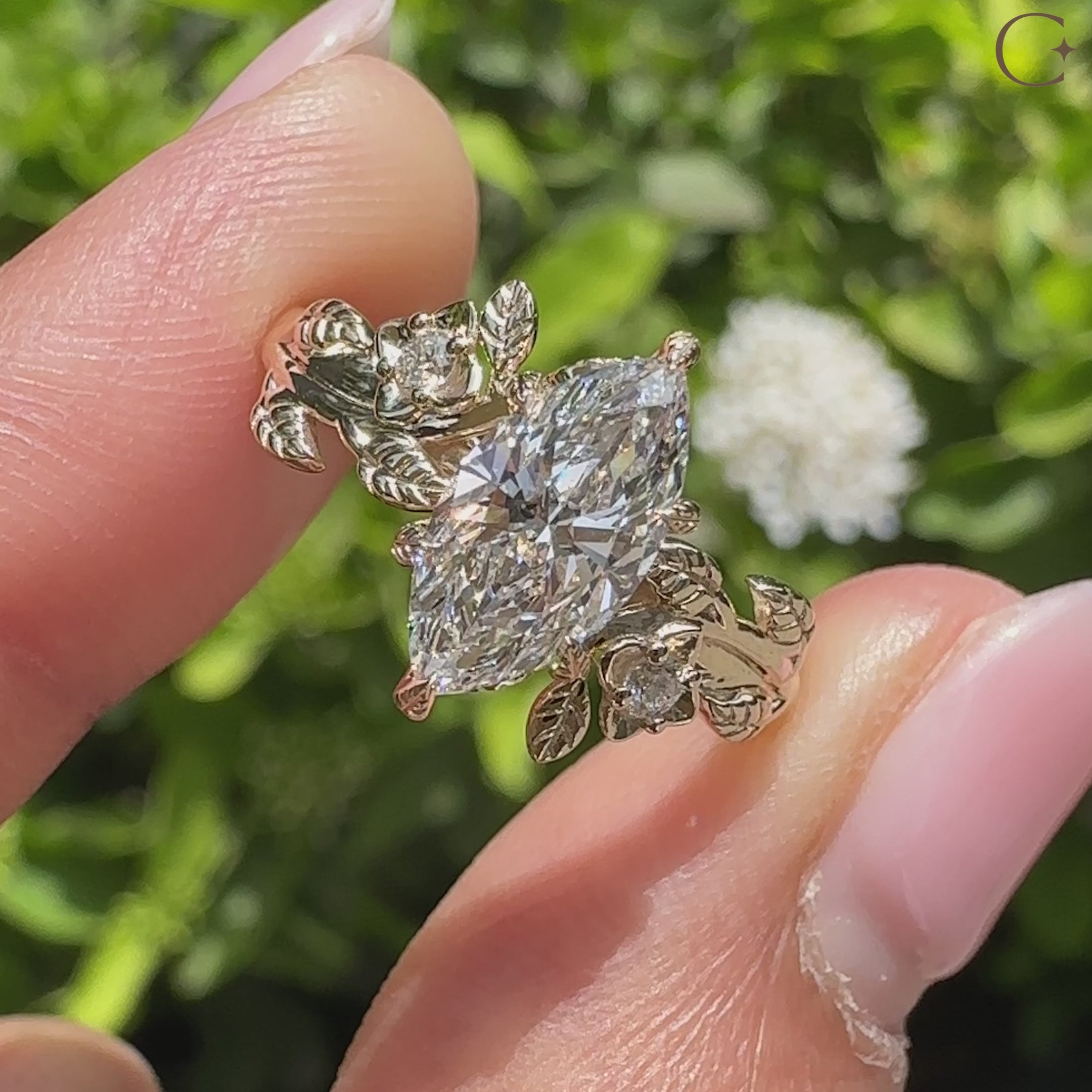Nature inspired marquise diamond ring with round side stones
