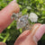 Nature inspired marquise diamond ring with round side stones
