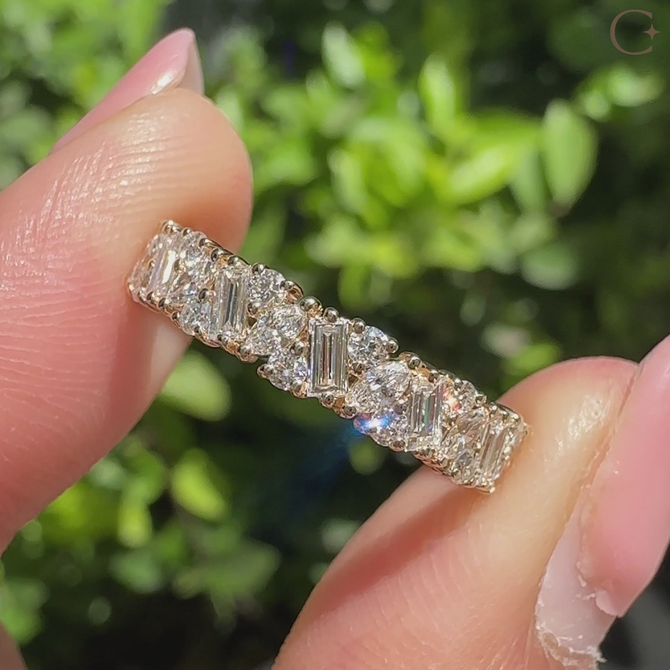 Lab grown diamond eternity band with mixed shape diamonds.
