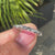 Round cut wedding band in white gold finish.
