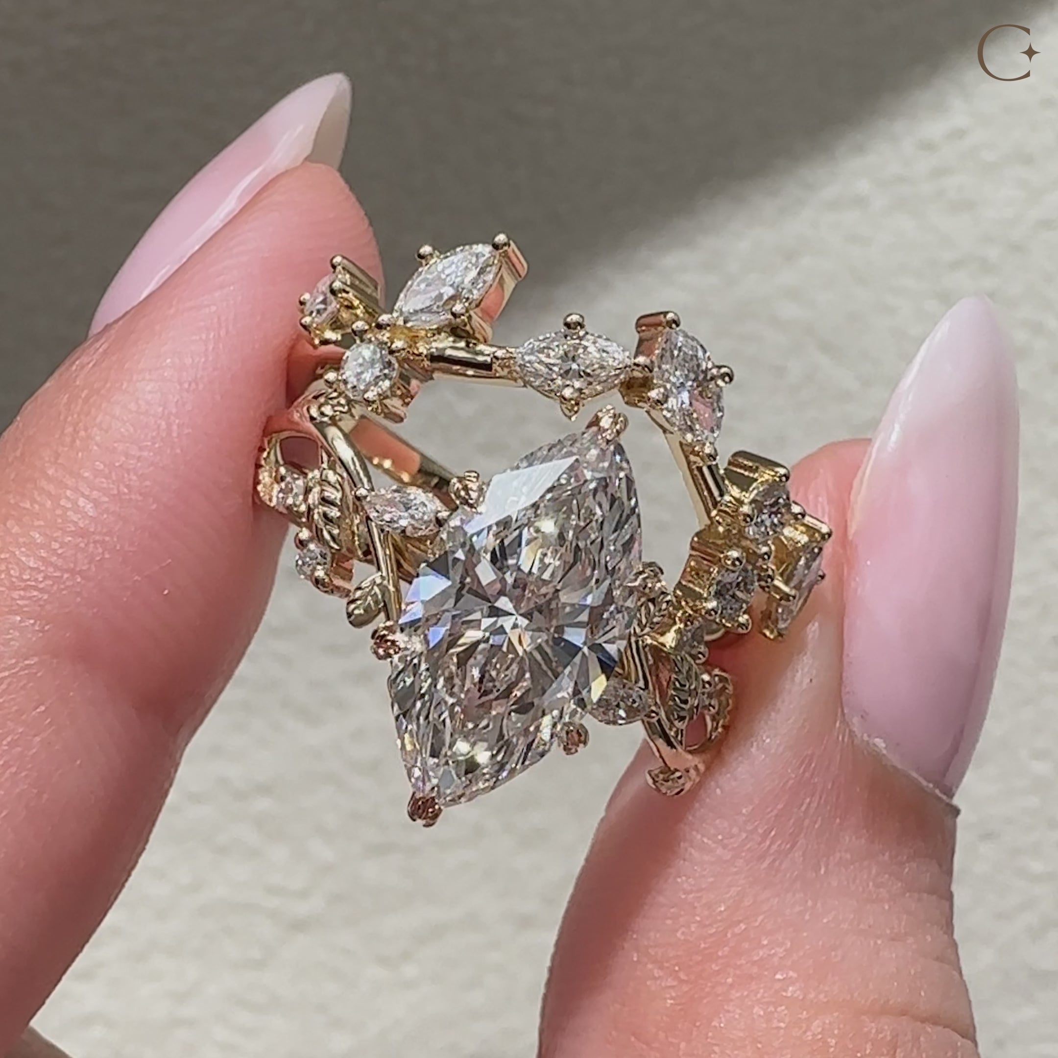 Marquise center diamond secured by six leaf style prongs.
