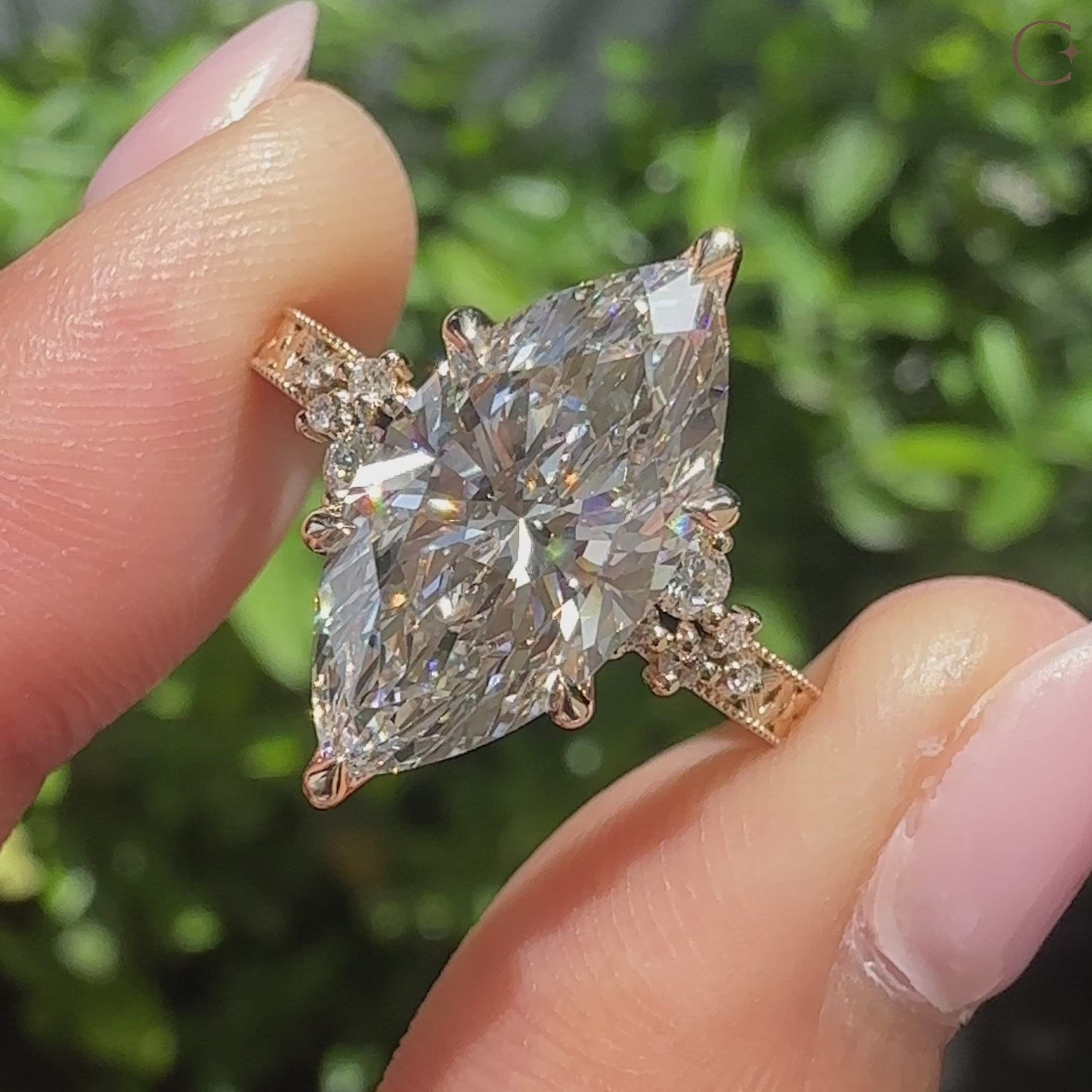 Marquise diamond ring with round side stones
