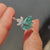 Seven stone engagement ring featuring pear cut cyan blue Moissanite and marquise side stones.