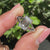 A stunning split shank ring featuring a four-claw prong setting, holding a beautiful lab-grown diamond certified by IGI.
