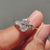 Oval ring with pear side stones for a unique look.
