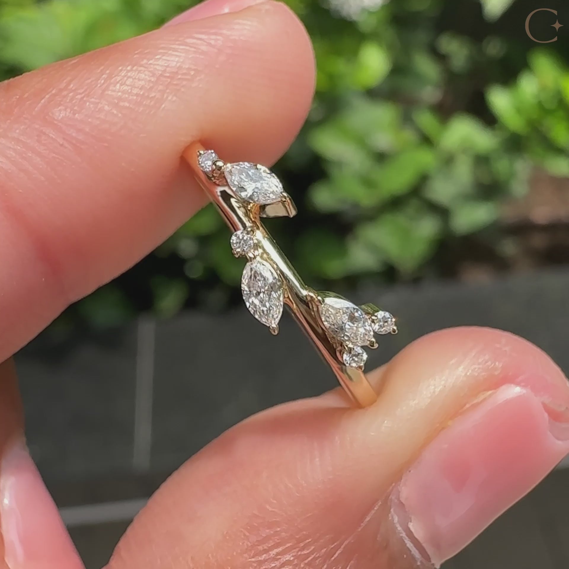 Yellow gold wedding ring with marquise diamond and round diamonds.