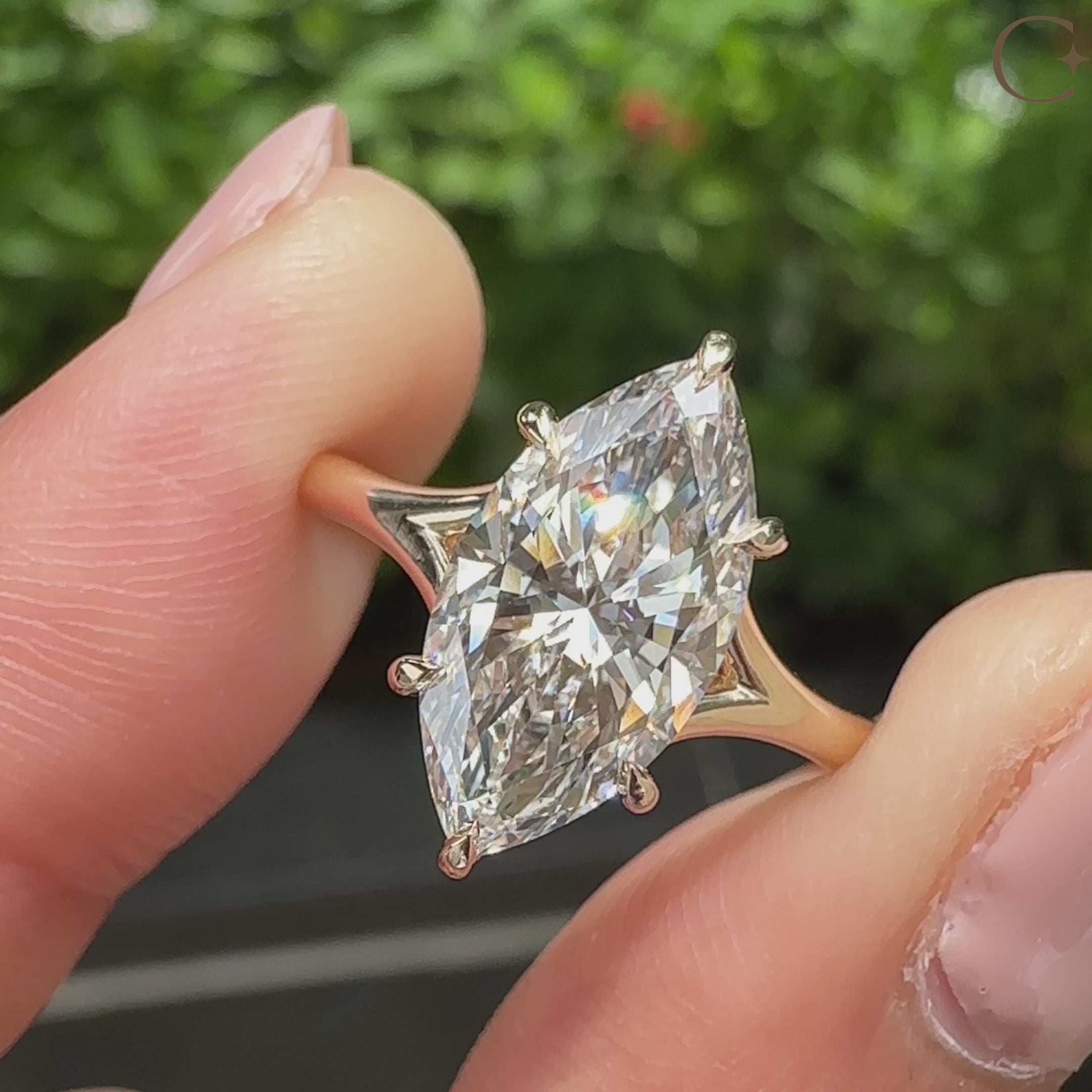 Marquise cut center diamond with split shank and five claw prong setting