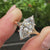 Marquise cut center diamond with split shank and five claw prong setting