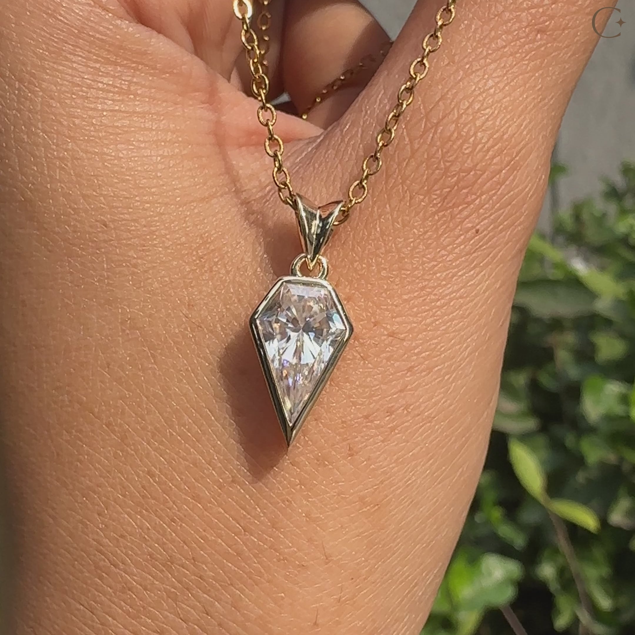 Handmade spear cut moissanite pendant in bezel style.
