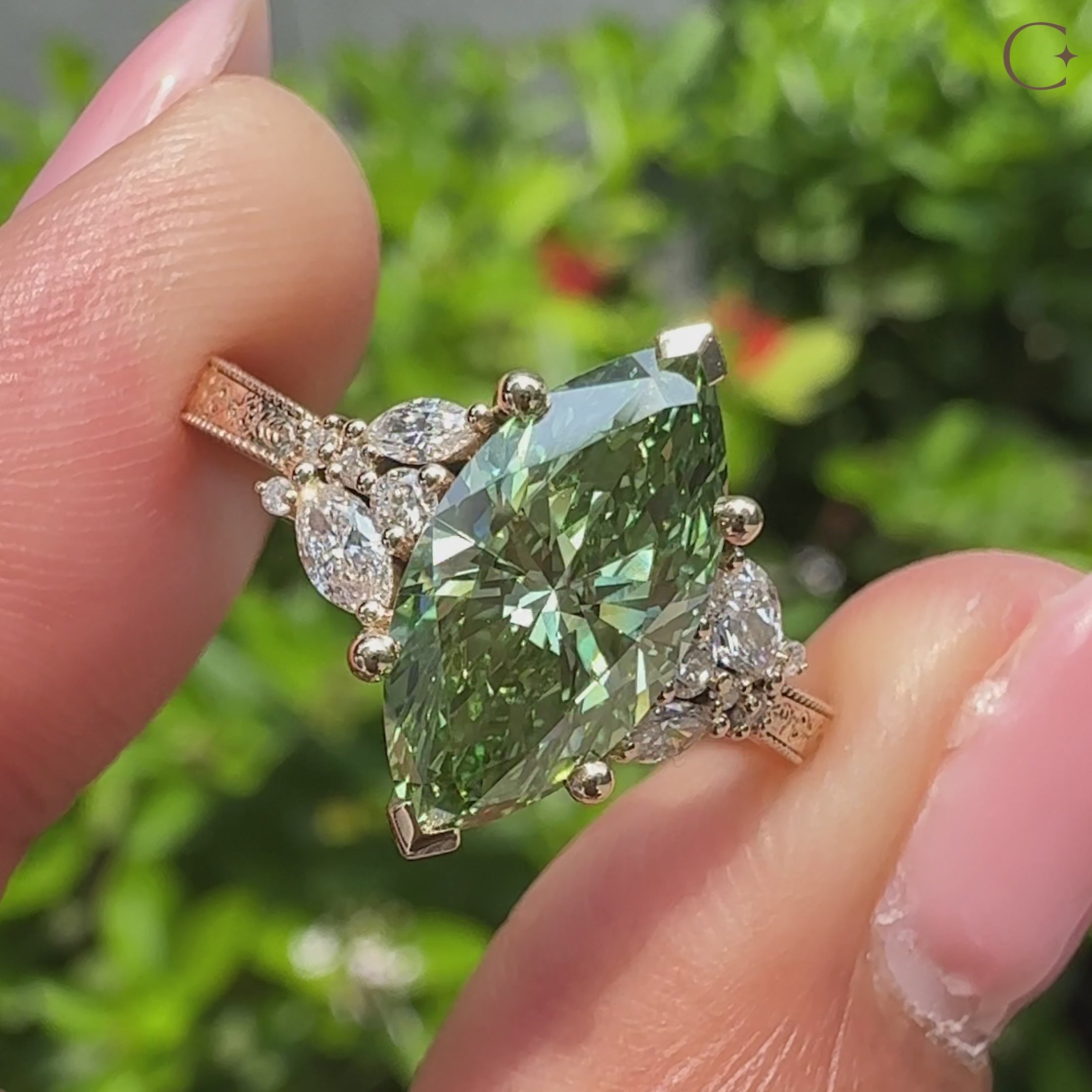 Green marquise ring with marquise and round side stones.
