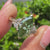 Green marquise ring with marquise and round side stones.
