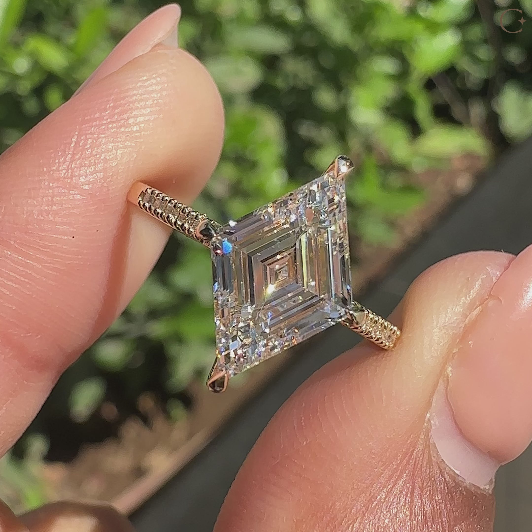 Lozenge cut diamond ring with compass prong setting.

