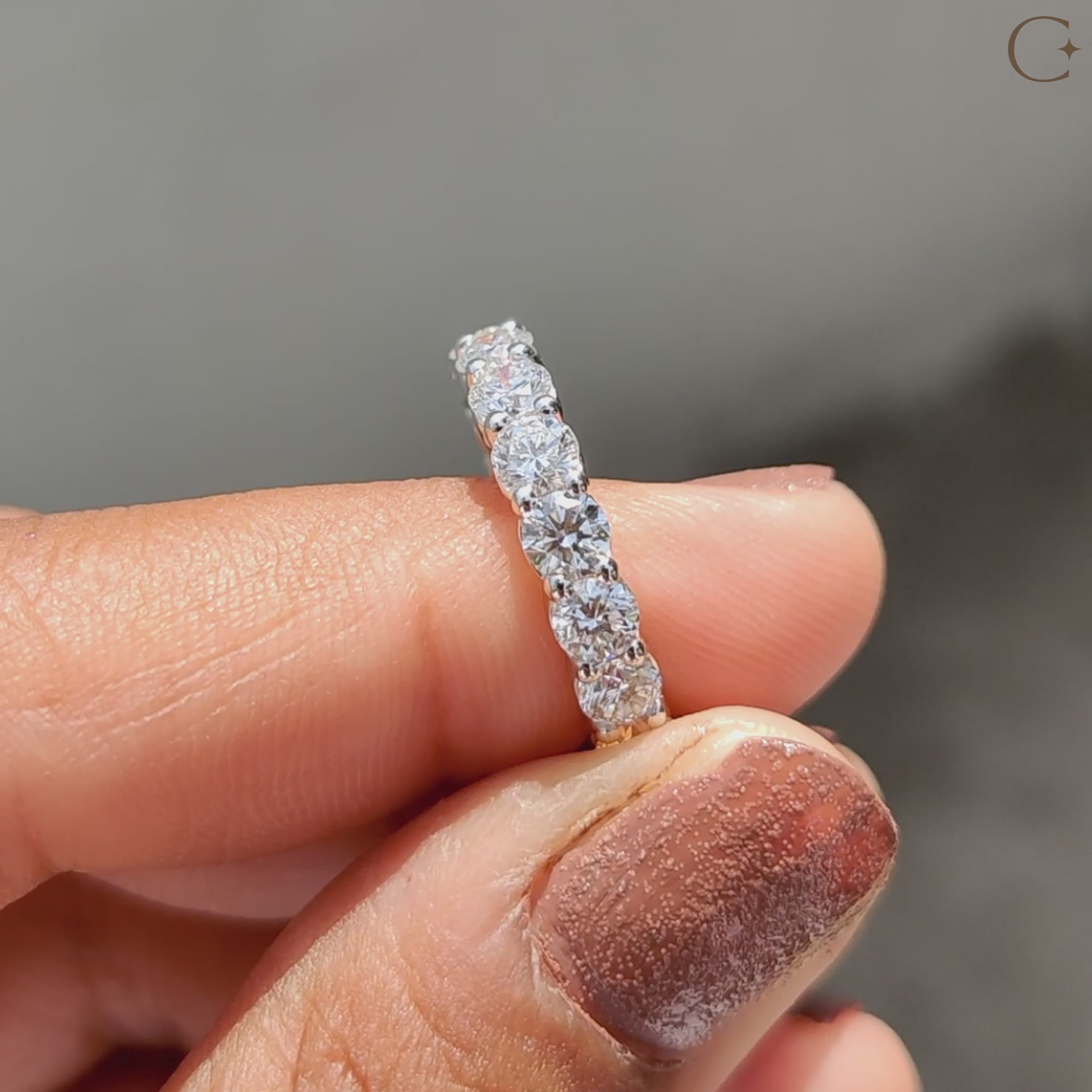 Full eternity band placed flat on a smooth marble surface.
