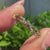 Round diamond wedding band in twisted yellow gold.
