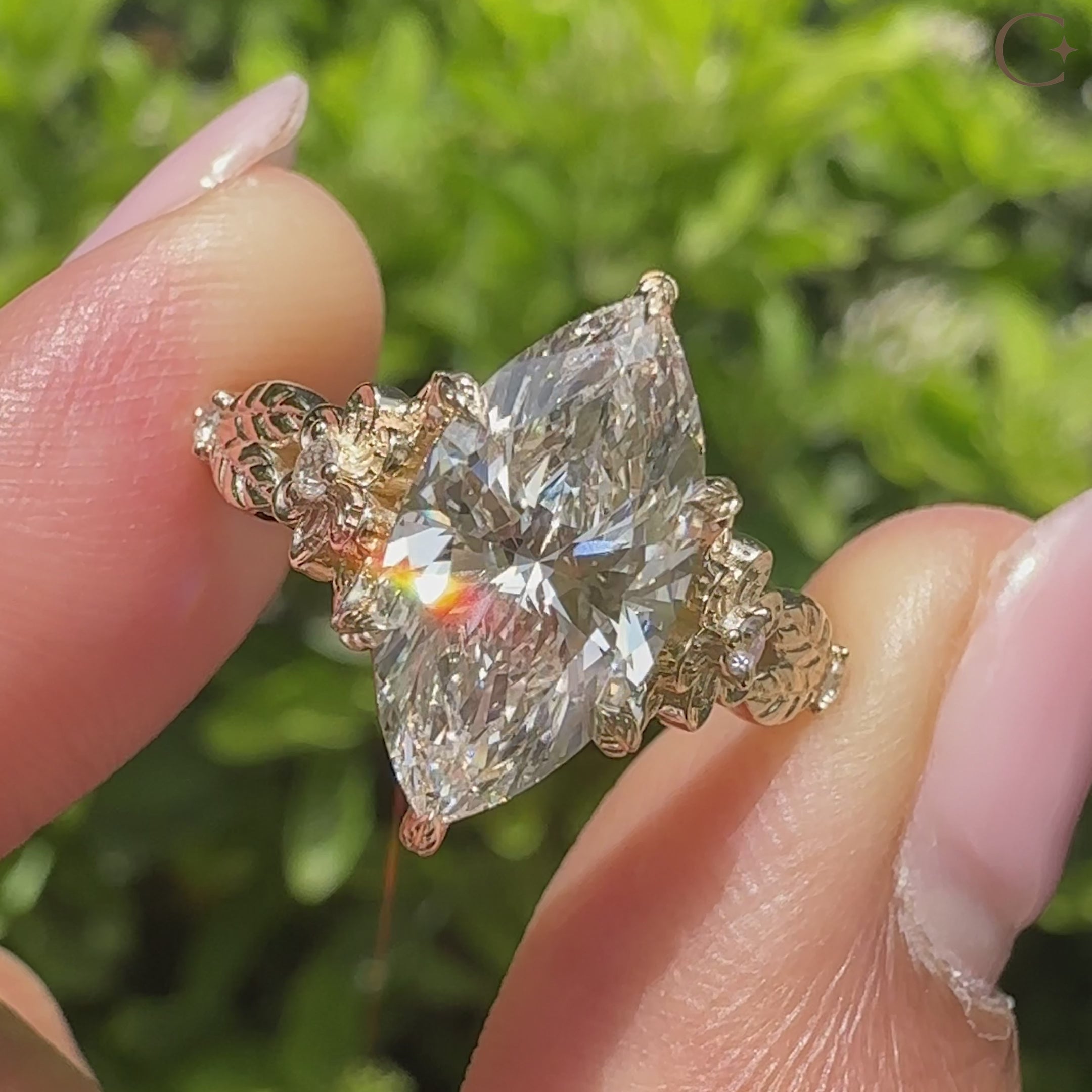 Marquise diamond ring with floral design and round accents
