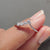 Round moissanite band designed with a vintage-style chevron pattern.