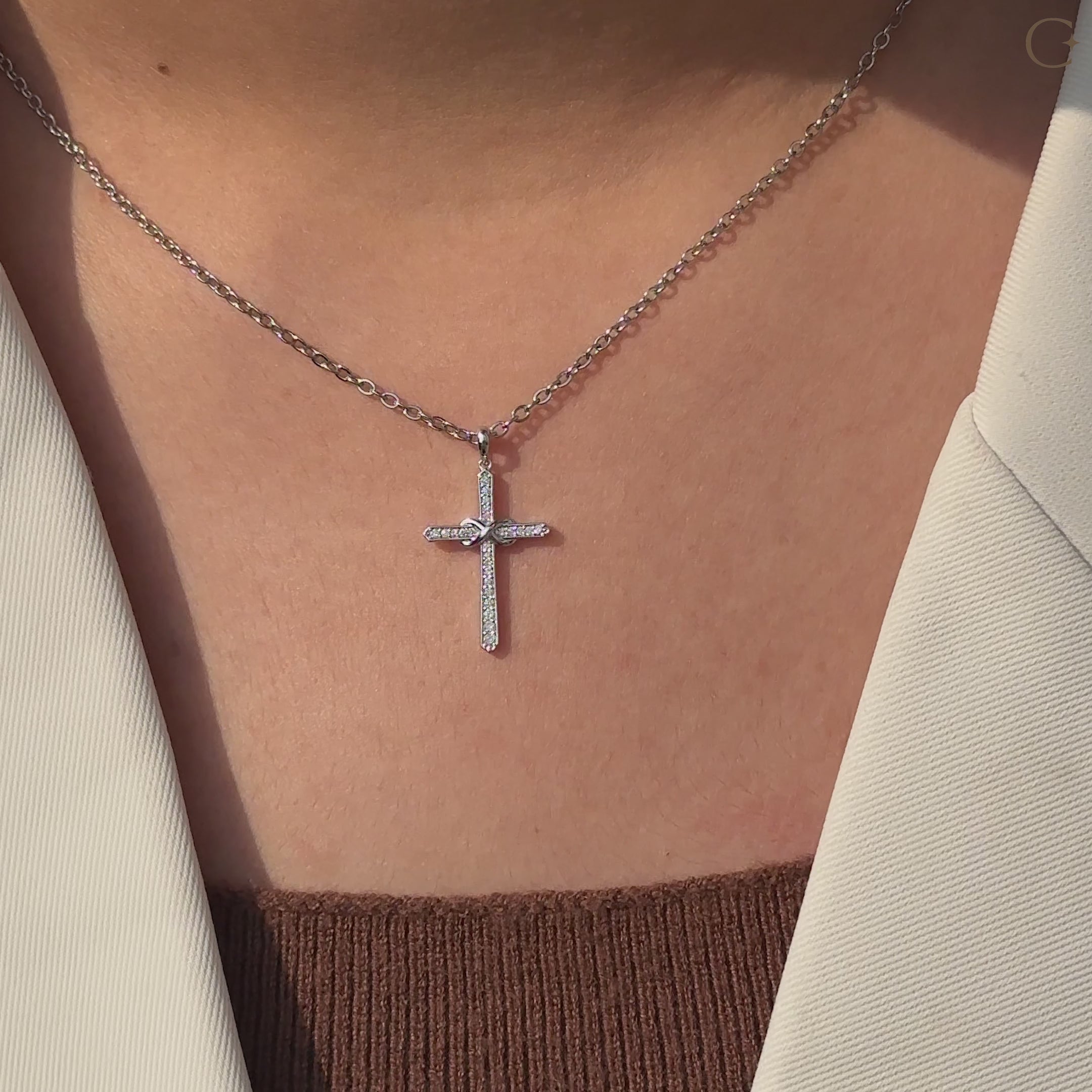 Round cut diamond pendant in a cross design.
