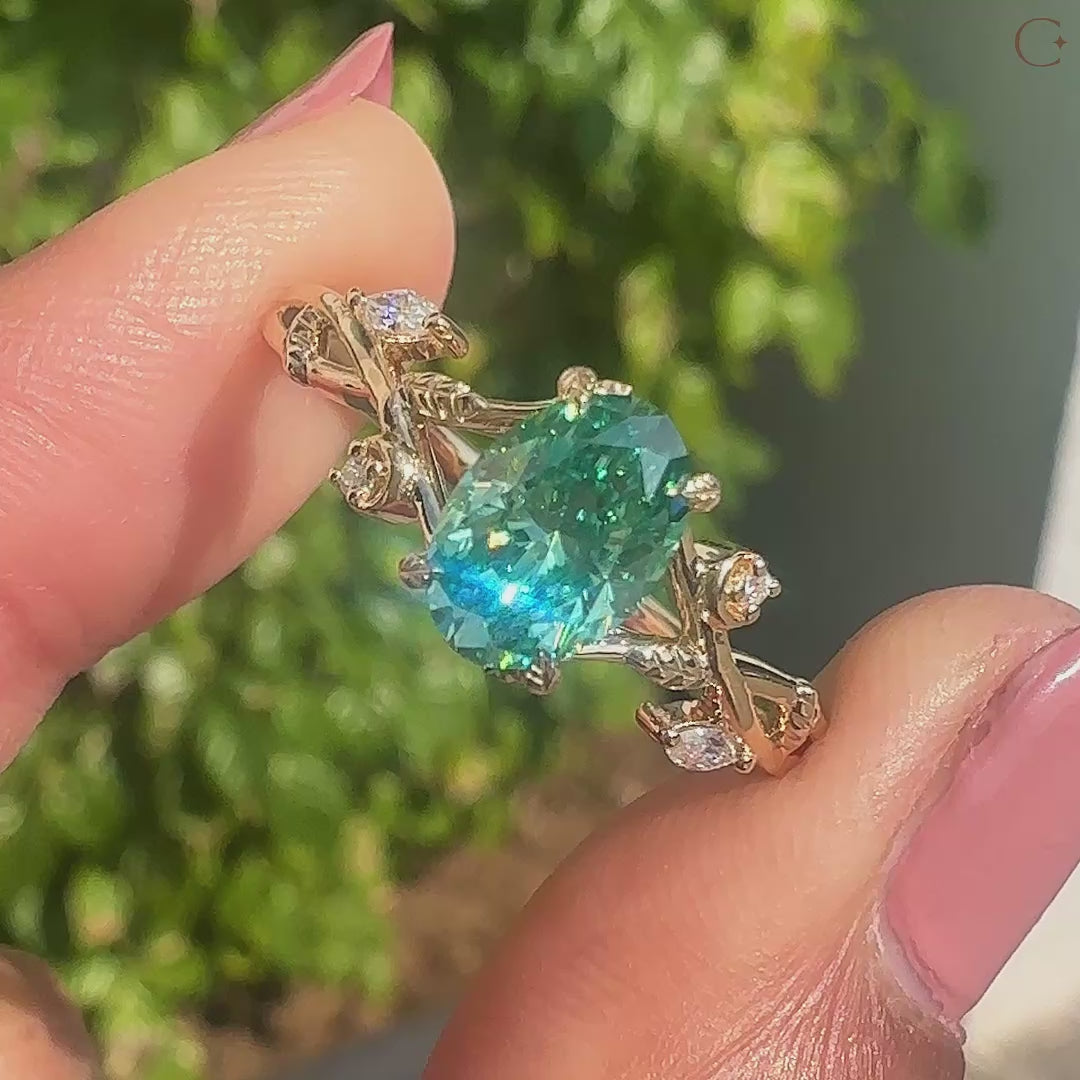 Oval cut moissanite ring with round and marquise side stones.
