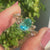 Oval cut moissanite ring with round and marquise side stones.
