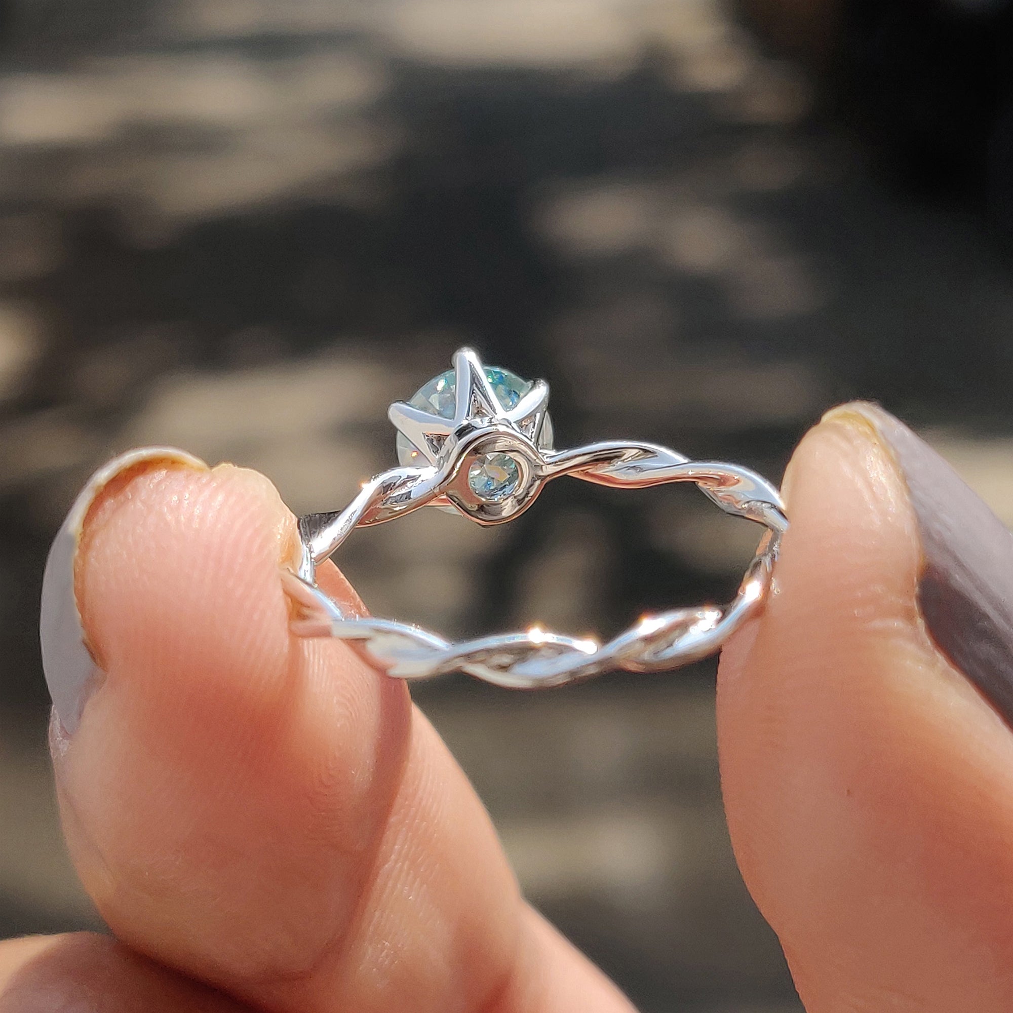 This twisted solitaire engagement ring adds depth and elegance to the center stone.
