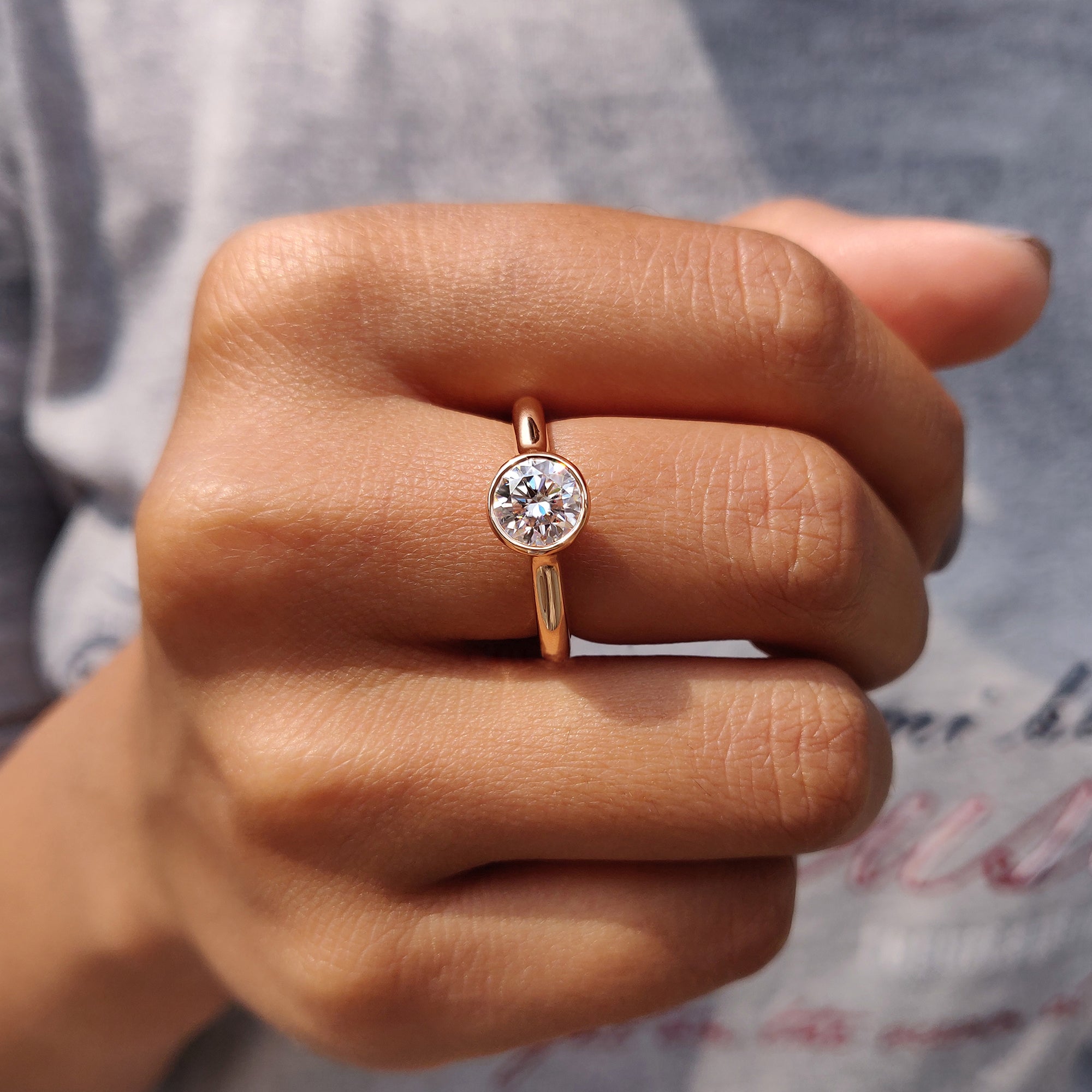 Round solitaire engagement ring in rose gold.