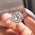 This halo engagement ring features a sparkling moissanite centerpiece.
