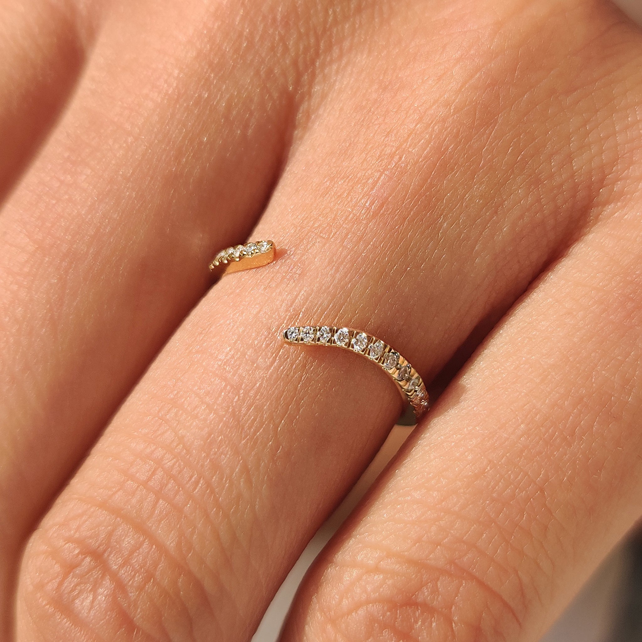 Stackable open gap wedding band with round diamond detail
