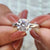 Solitaire ring with a round cut moissanite stone.
