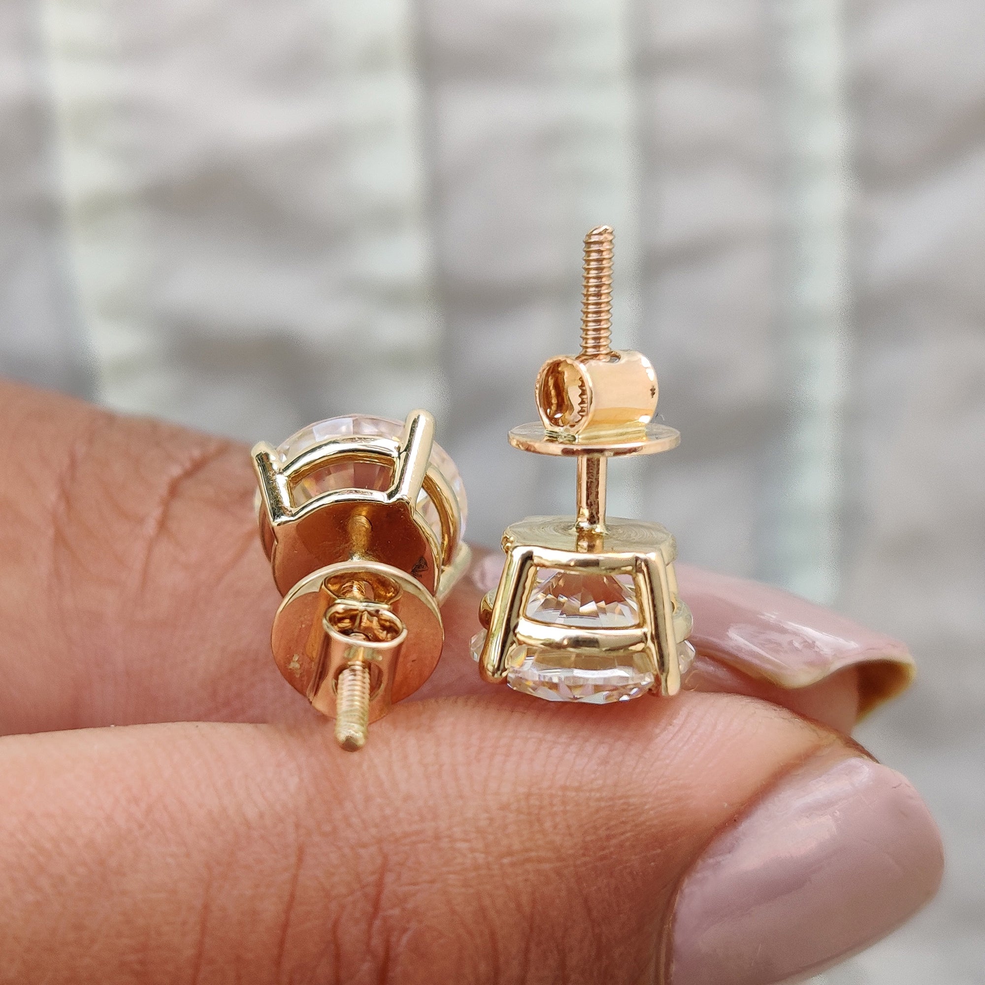 Stud earrings made with round cut moissanite and screw back earrings style.
