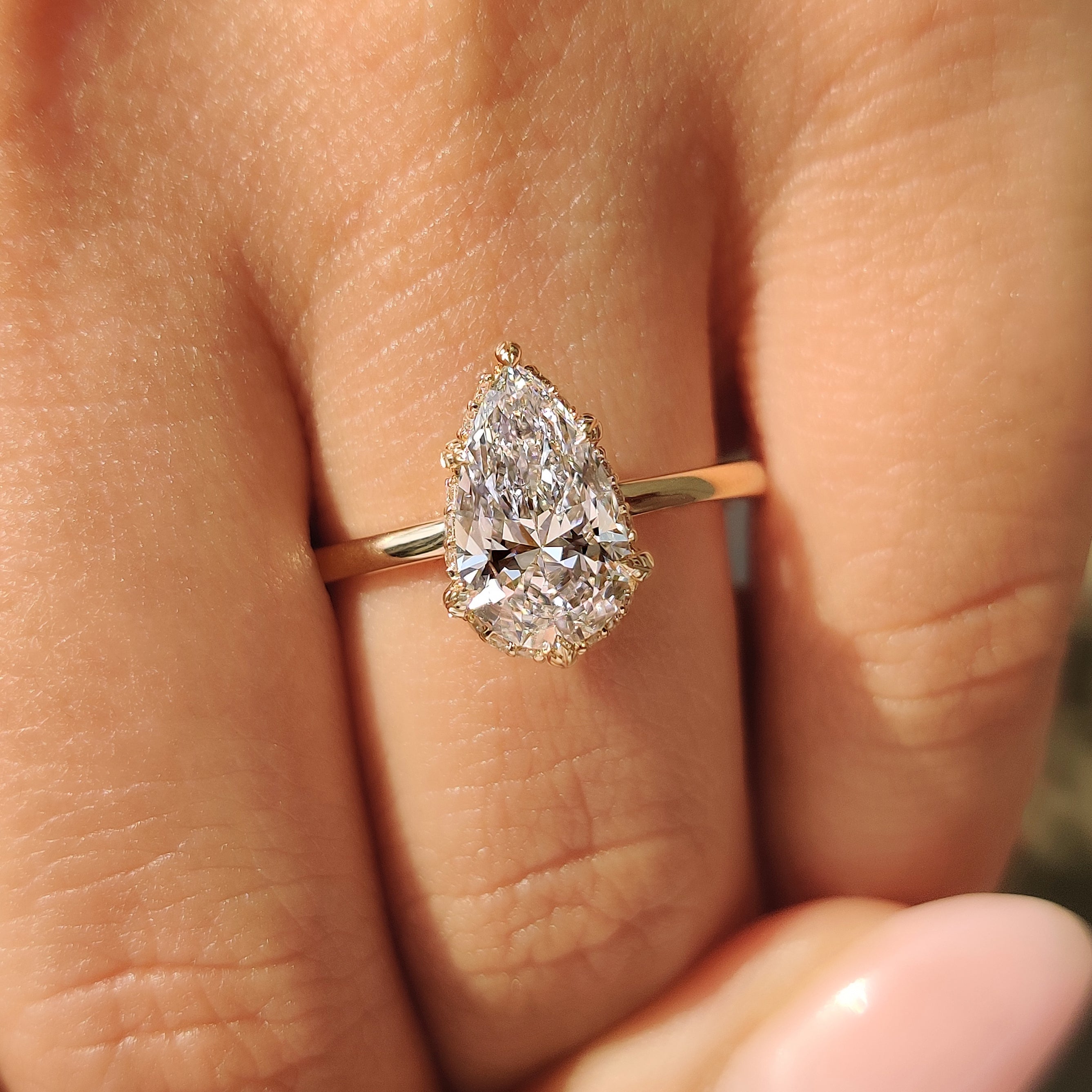 Pear cut diamond ring with round hidden halo.
