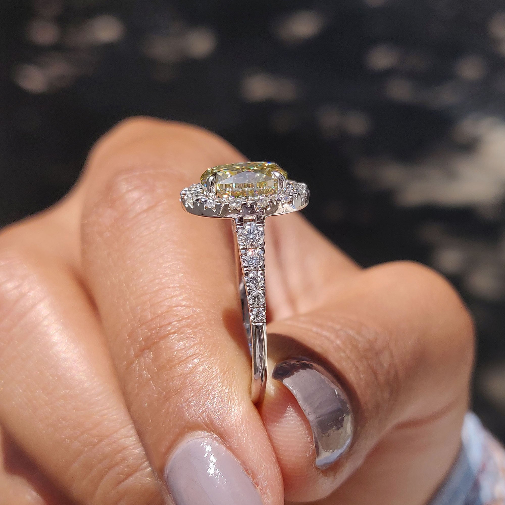 Light yellow moissanite ring with a micro pave setting.