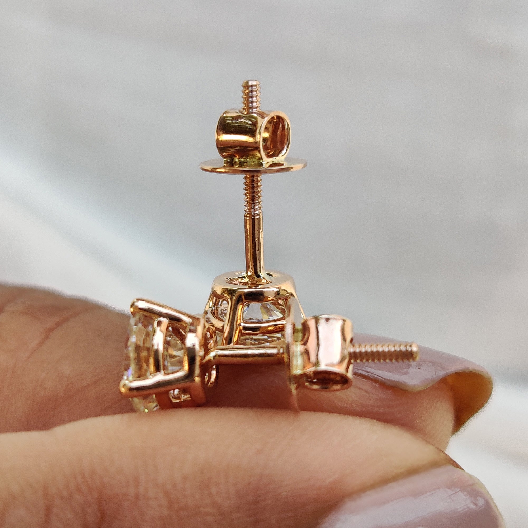 Gold Moissanite Earrings featuring 4 prong setting and stud earrings layout.
