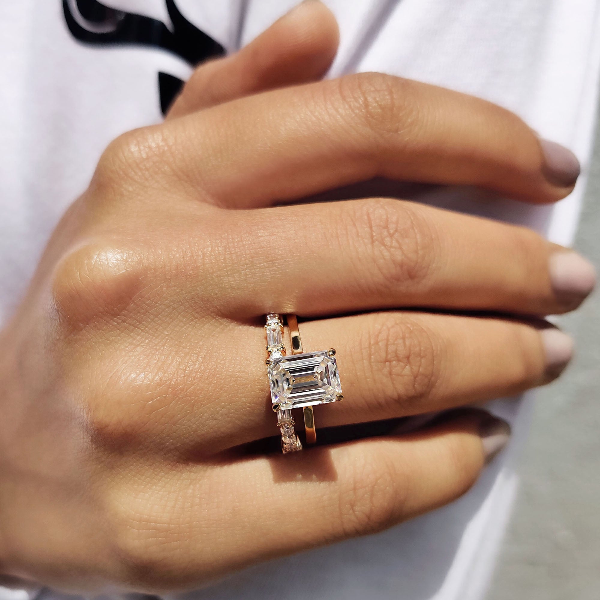 Moissanite bridal set featuring a prong setting ring and eternity wedding band.
