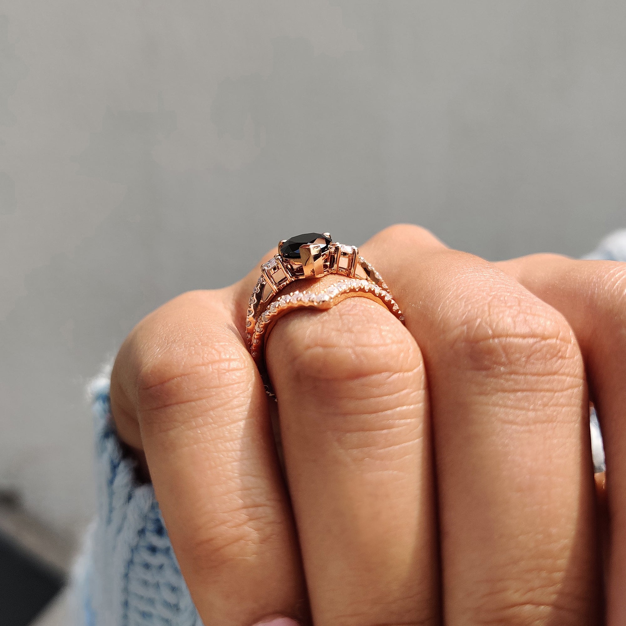 Black Moissanite ring with a v prong setting and curved band design.
